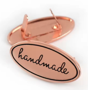 decorate your handbag with an oval handmade badge in rose gold, with prongs and washer for easy fitting