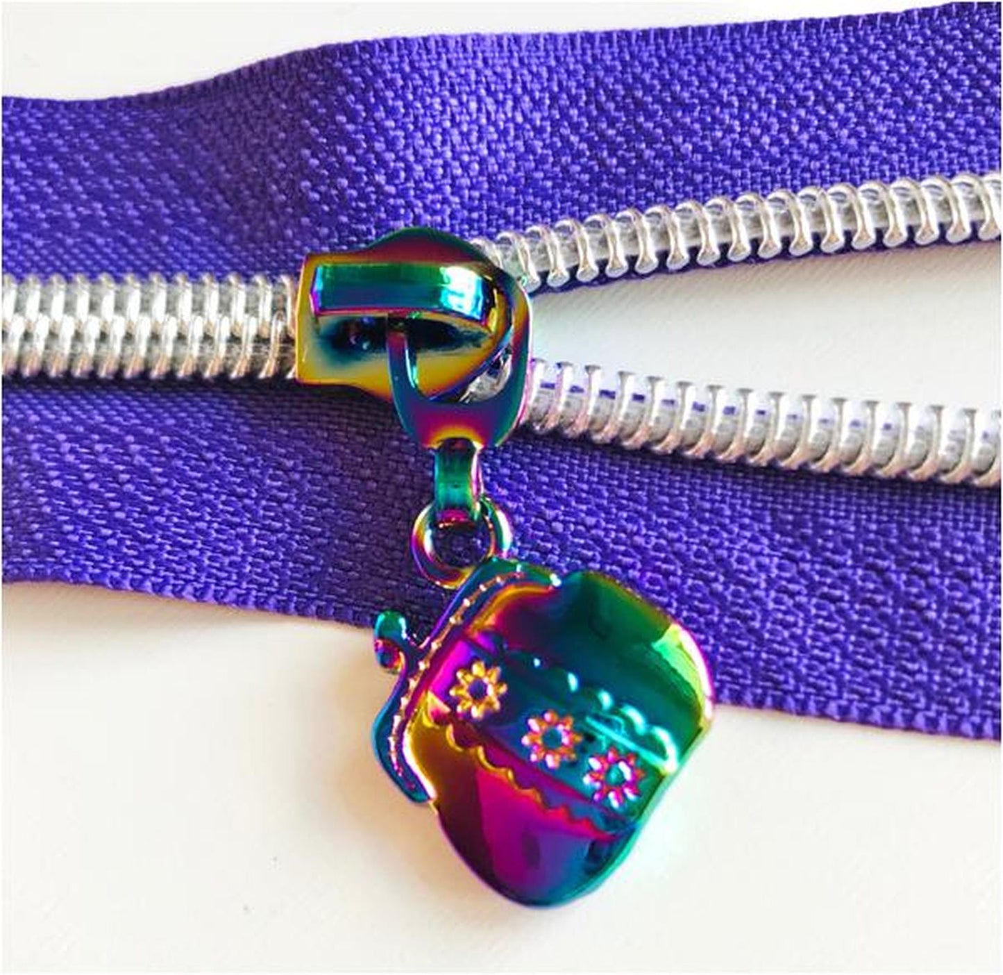 Handbag shaped zip pulls in two colours, silver or rainbow, sold in packs of 4 at Bobbin Girl