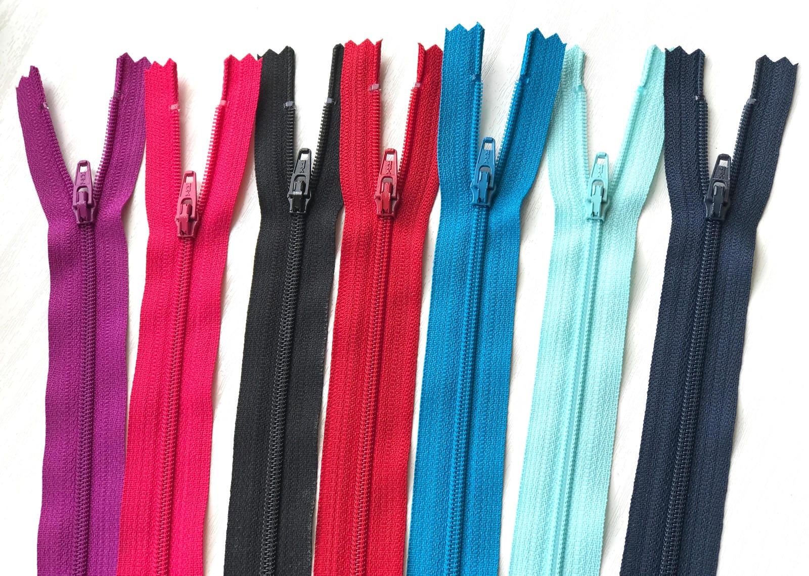 10" zips in severn different colours, magenta, hot pink, black, red, Mediterranean blue, aqua and navy 