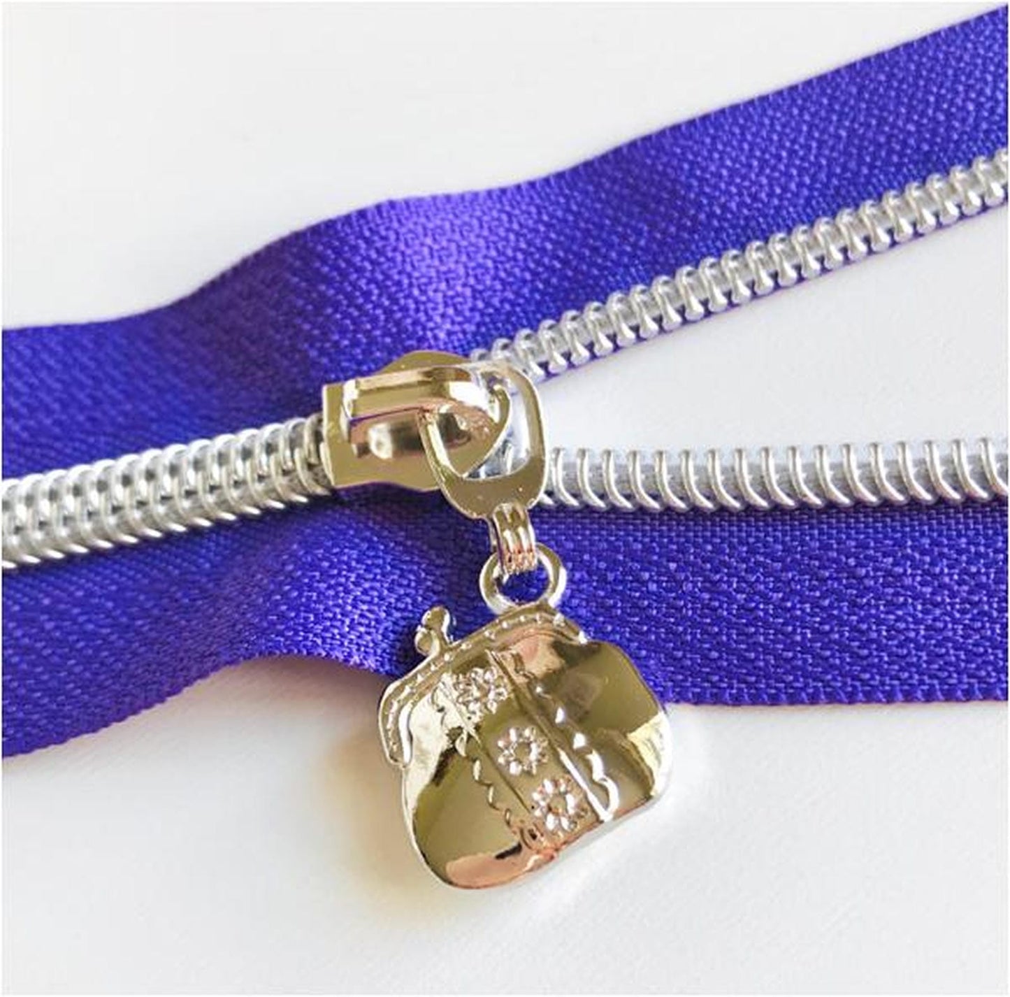 Handbag shaped zip pulls in two colours, silver or rainbow, sold in packs of 4 at Bobbin Girl 