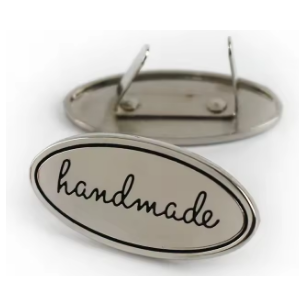 decorate your handbag with an oval handmade badge in silver, with prongs and washer for easy fitting